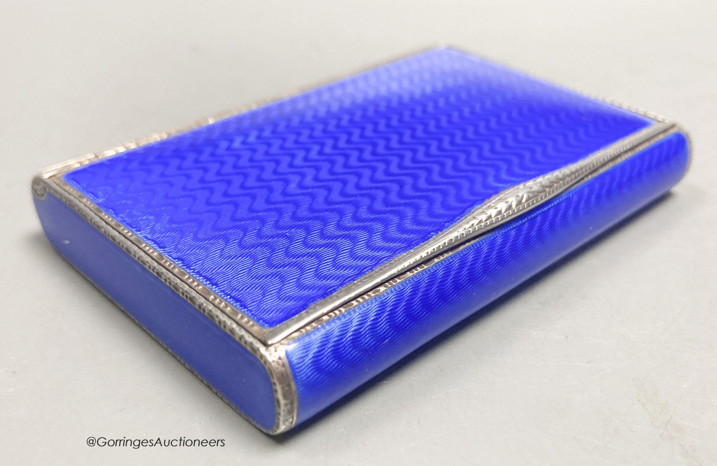 A 1920's continental silver and blue guilloche enamel rectangular box with hinged cover, import marks for DC, London, 1927, 77mm by 55mm by 12mm